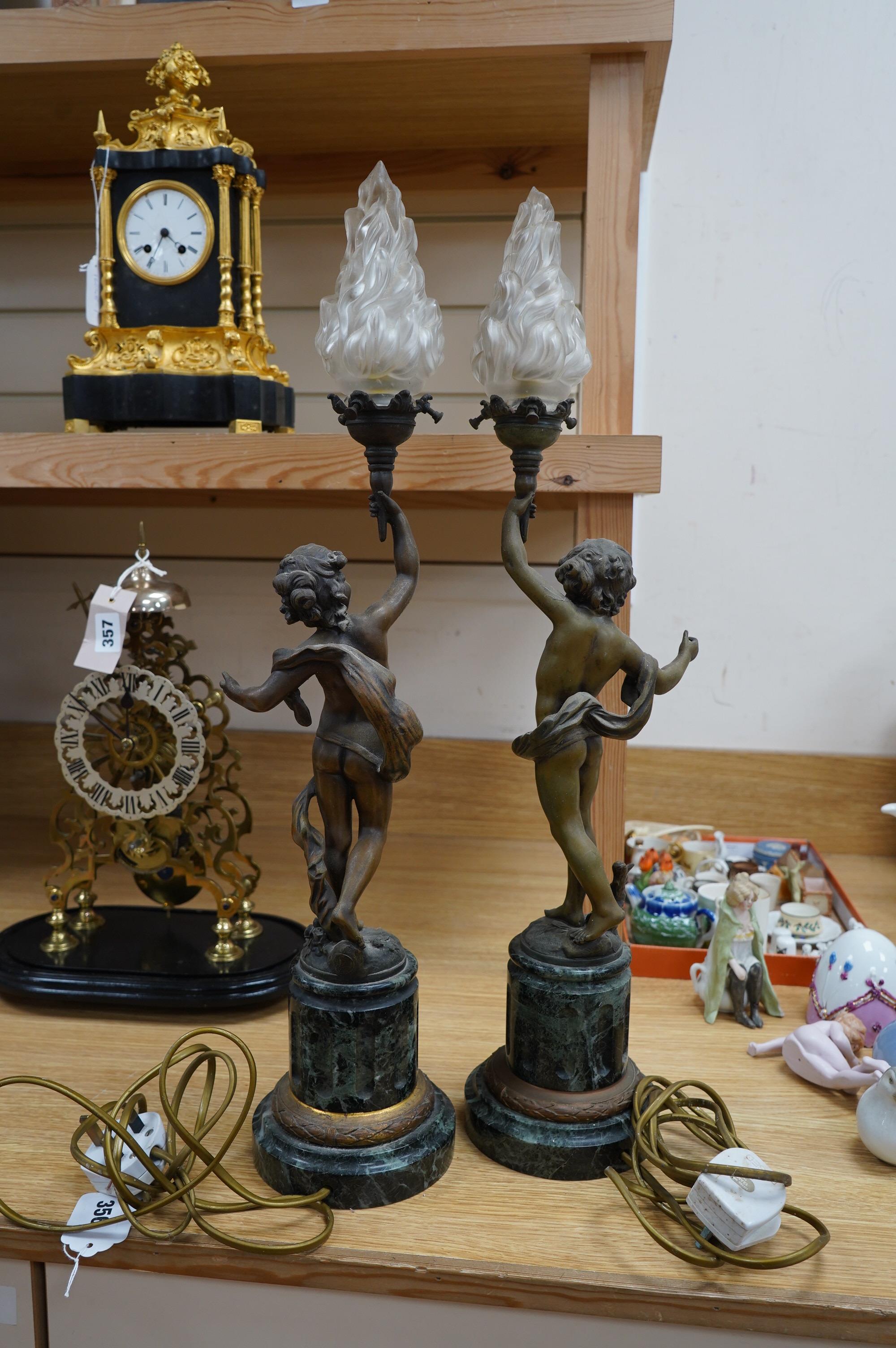 A pair of bronzed spelter ‘putto’ lamps, serpentine marble bases, 60cm. Condition - fair to good, not tested